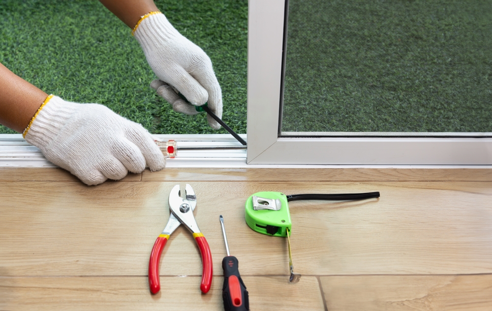 professional contractor performing a door replacement for an indoor outdoor glass sliding door