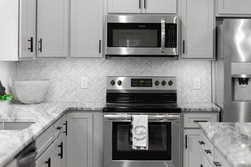 stainless steel appliances with marble countertops