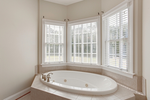 Sunlit,Bathroom,With,An,Elegant,Bathtub,With,A,Large,Bay